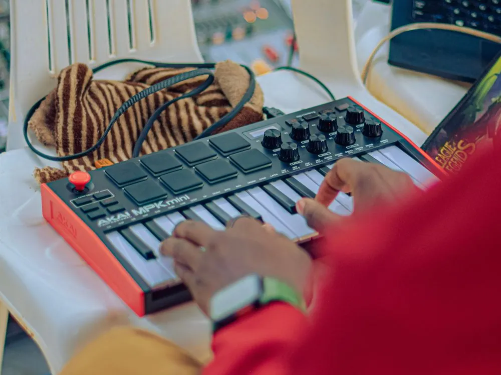Hands on a synthesiser in a studio